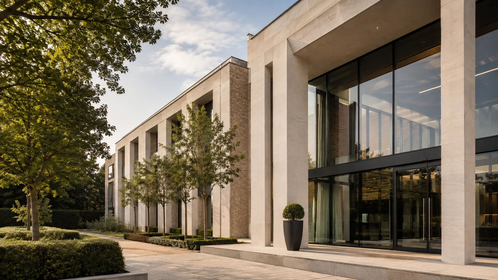 Limestone building in landscaped grounds