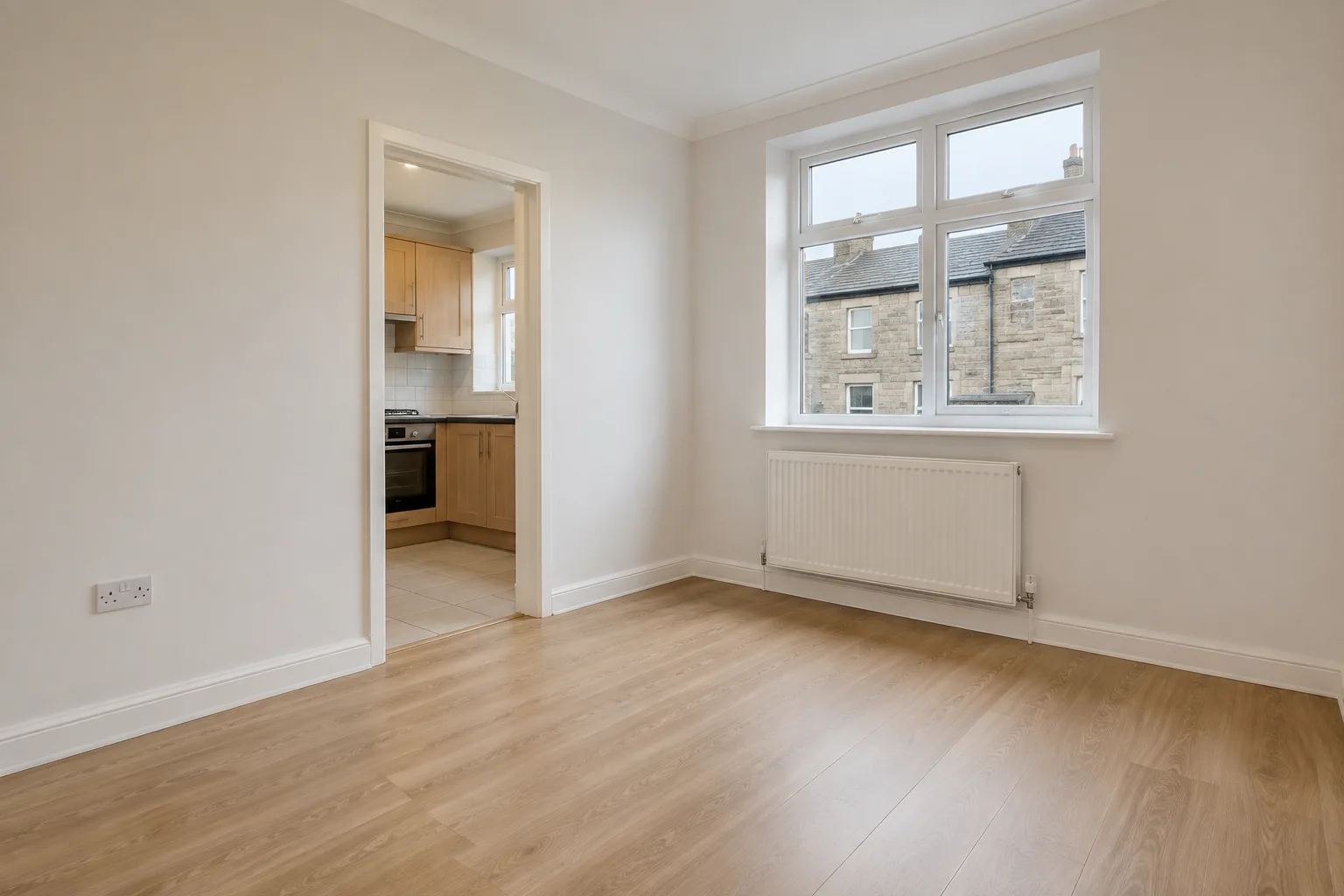 Empty room with white walls, timber flooring and a sash window